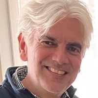 Photo of Fredric Besnard smiling by a window